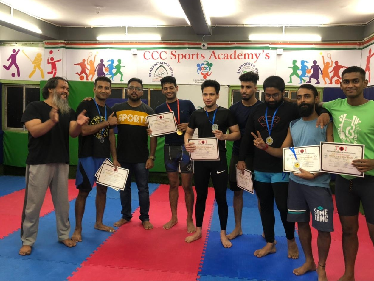 Fighters with certificates and medals at a sports academy event